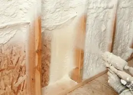 Spray foam insulation being applied in a wall.